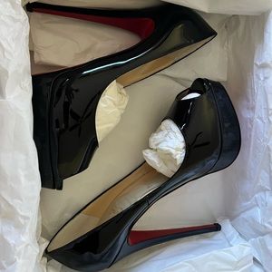 Christian Louboutin lady peep, discontinued, black patent leather pump.